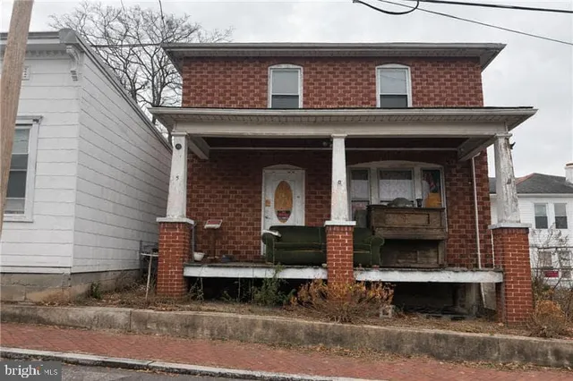 a front view of a house with parking