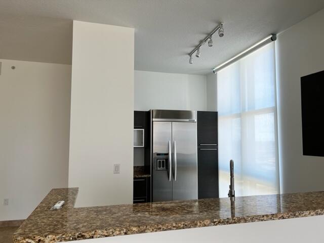 550 Okeechobee Boulevard, Unit MPH02 West Palm Beach, FL 33401 - Photo 11 of 32 a view of a refrigerator in kitchen and a sink
