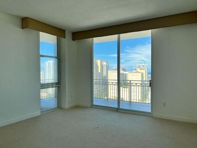 550 Okeechobee Boulevard, Unit MPH02 West Palm Beach, FL 33401 - Photo 13 of 32 an empty room with windows