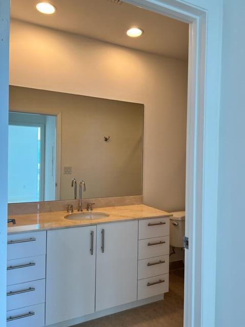 550 Okeechobee Boulevard, Unit MPH02 West Palm Beach, FL 33401 - Photo 27 of 32 a bathroom with a sink and a mirror