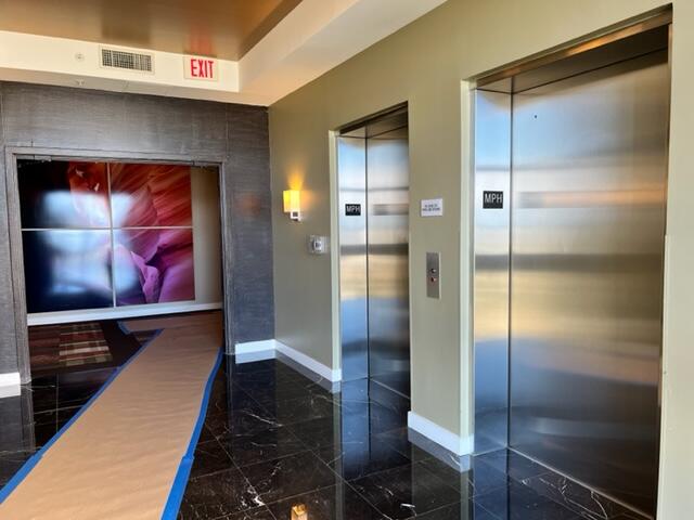 550 Okeechobee Boulevard, Unit MPH02 West Palm Beach, FL 33401 - Photo 31 of 32 a hallway with wooden floor