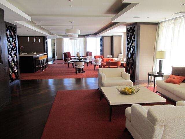 550 Okeechobee Boulevard, Unit MPH02 West Palm Beach, FL 33401 - Photo 5 of 32 a living room with furniture and a flat screen tv