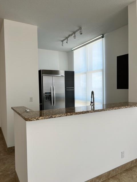 550 Okeechobee Boulevard, Unit MPH02 West Palm Beach, FL 33401 - Photo 6 of 32 a bathroom with a granite countertop sink and a mirror
