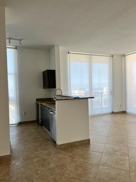 550 Okeechobee Boulevard, Unit MPH02 West Palm Beach, FL 33401 - Photo 8 of 32 a view of a kitchen with a sink and a stove top oven