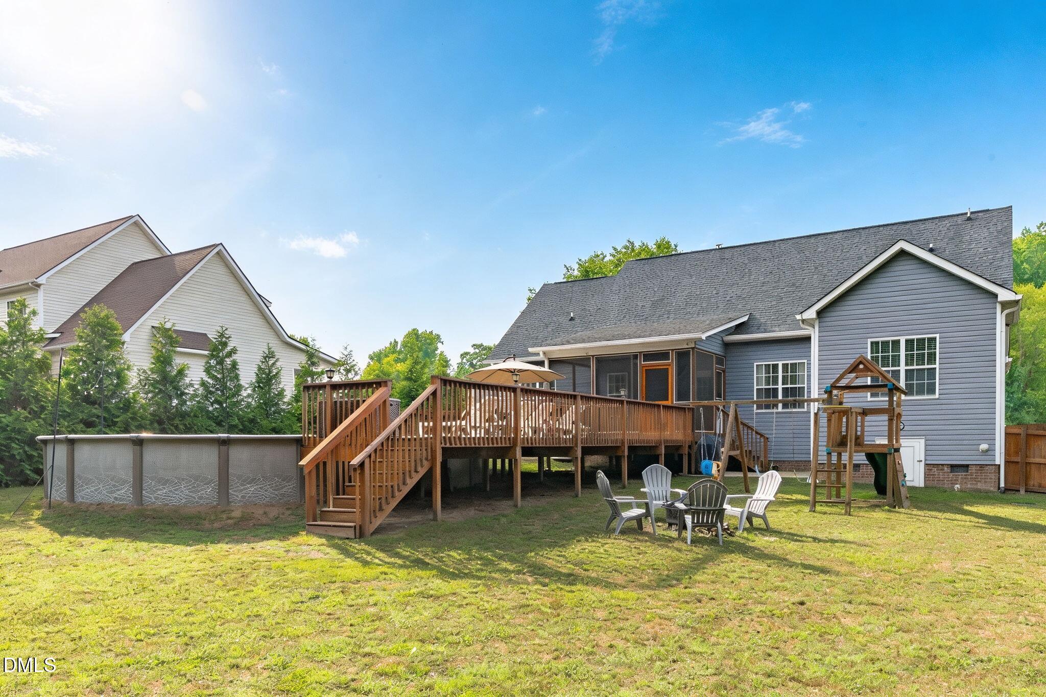 2450 Rolling Tracks Road Willow Spring, NC 27592 - Photo 52 of 64 a view of a house with swimming pool and sitting area