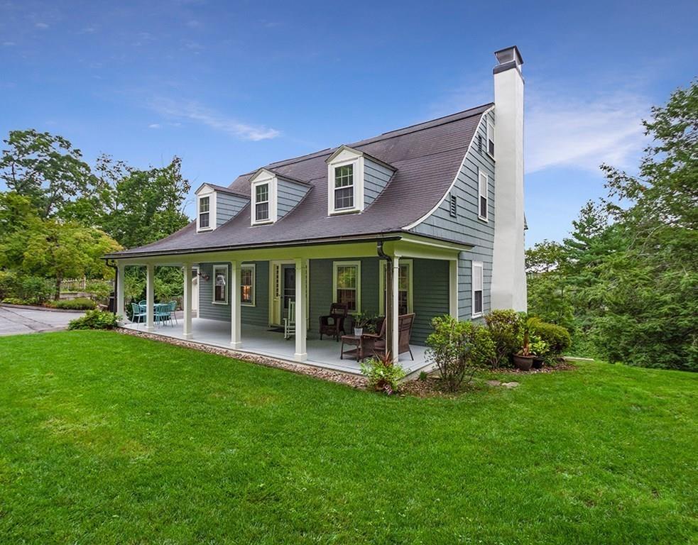 14 Hilliard Road Lincoln, MA 01773 - Photo 1 of 31 a front view of a house with a yard table and chairs