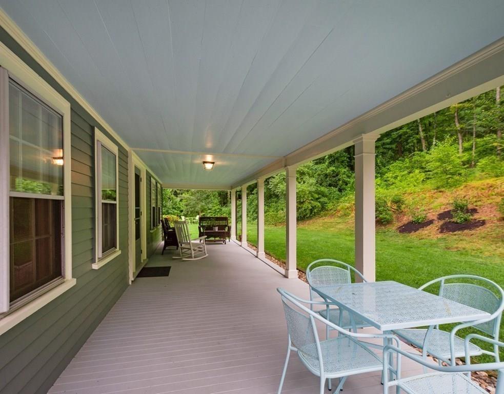 14 Hilliard Road Lincoln, MA 01773 - Photo 9 of 31 a view of a patio with chairs and floor to ceiling window