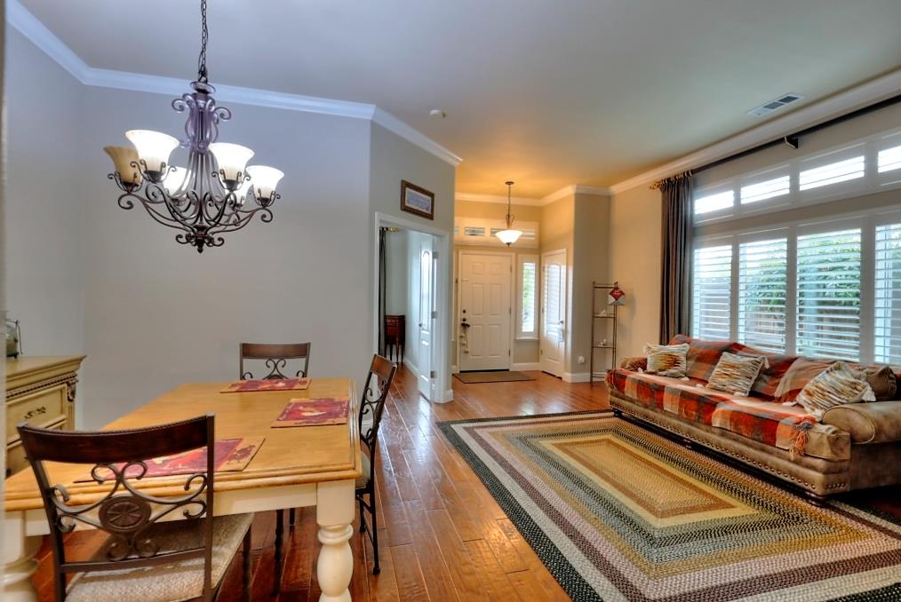 4152 Post Oak Drive Turlock, CA 95382 - Photo 21 of 71 a living room with dining table furniture and a chandelier