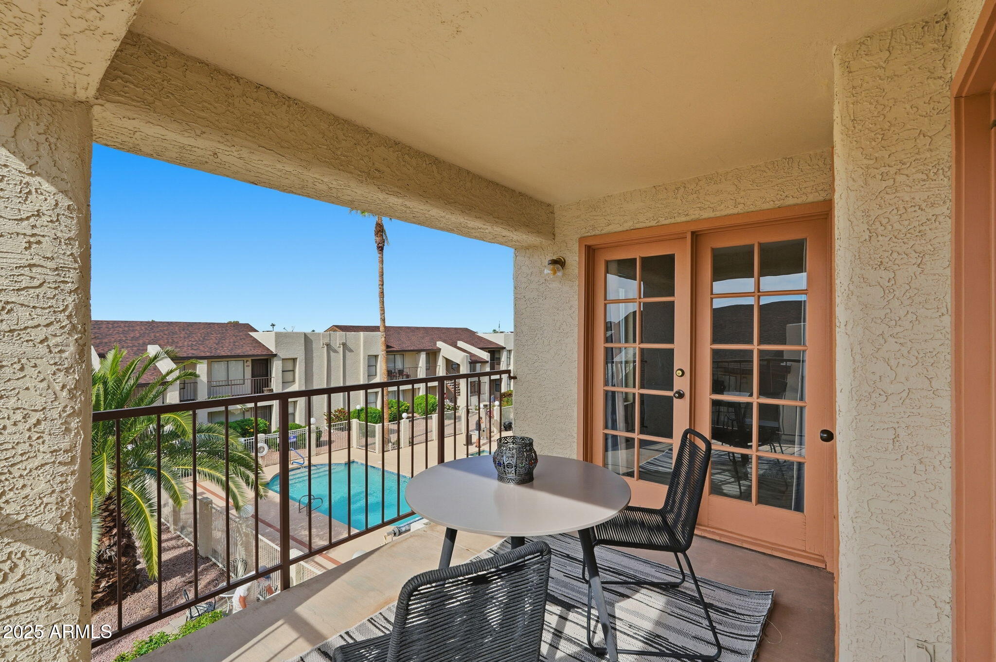 a view of a balcony with furniture and floor to ceiling window