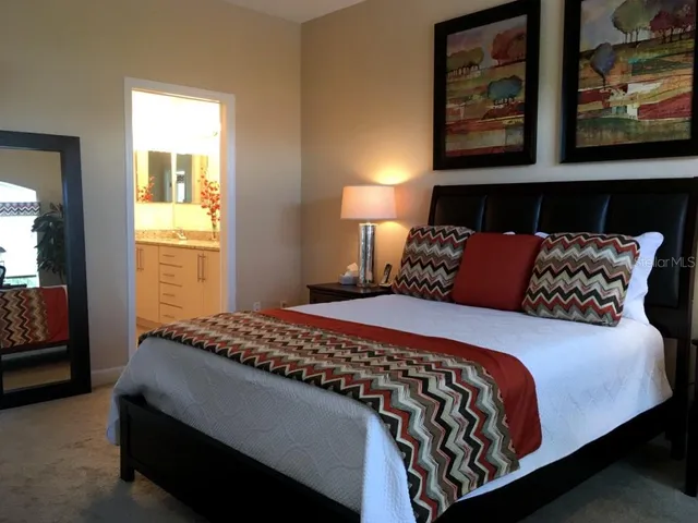 a bedroom with a large bed and a window