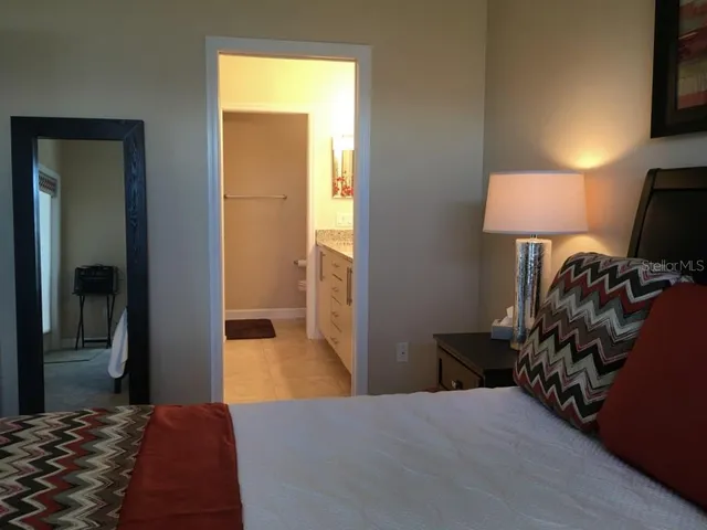 a bedroom with a bed and a lamp