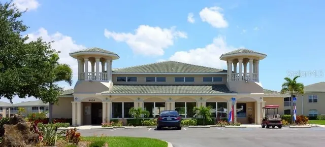 a view of a brick building with many windows and a table and chairs