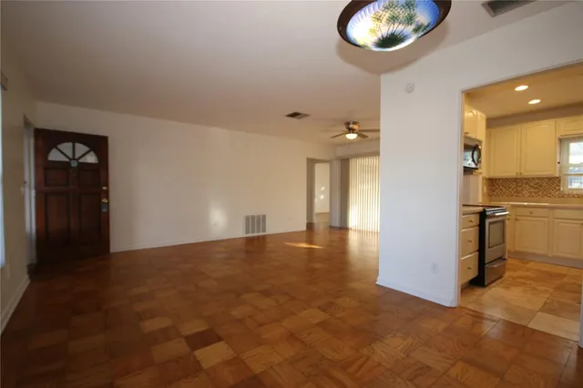 a view of a kitchen with a sink and a refrigerator