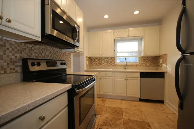 a kitchen with a sink stove and microwave