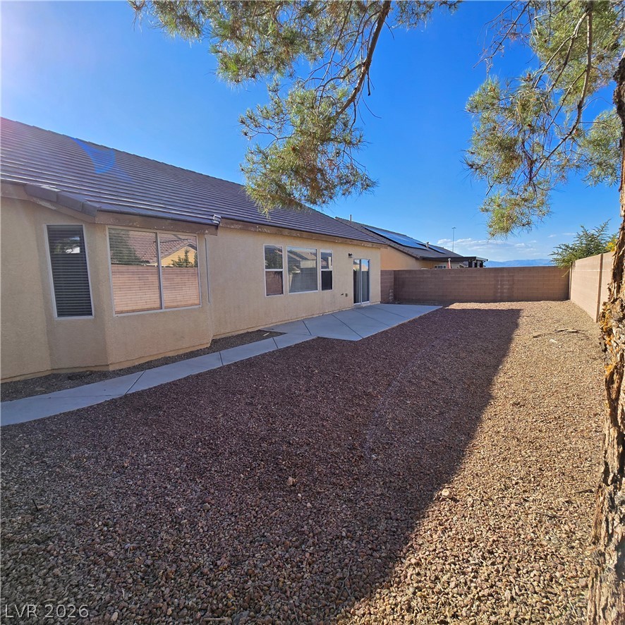 9234 Kingston Road Henderson, NV 89074 - Photo 3 of 38 A low-maintenance backyard retreat with a concrete patio and durable rock landscaping.