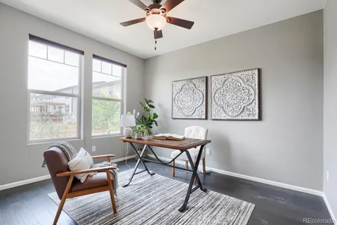 a workspace with wooden floor and a window