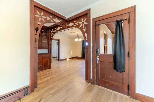 a view of a hallway with wooden floor