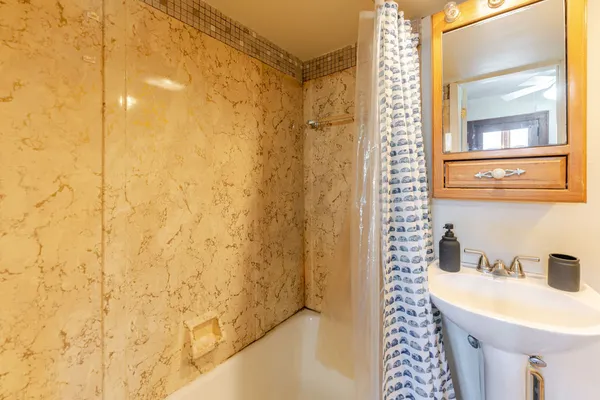 a bathroom with a sink and a mirror