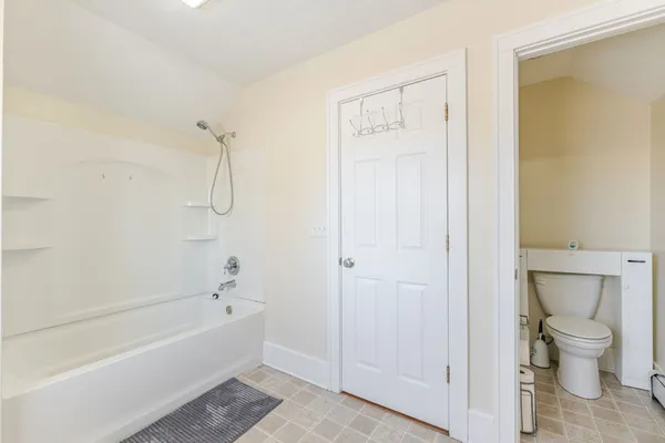 a bathroom with a bathtub and a toilet