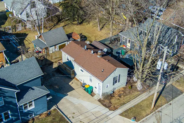 an aerial view of a house with a yard