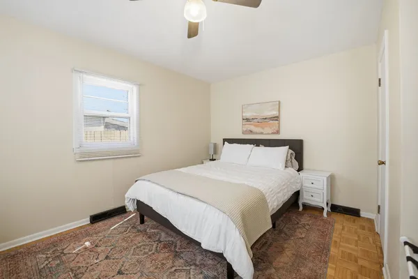 a bedroom with a bed and a window
