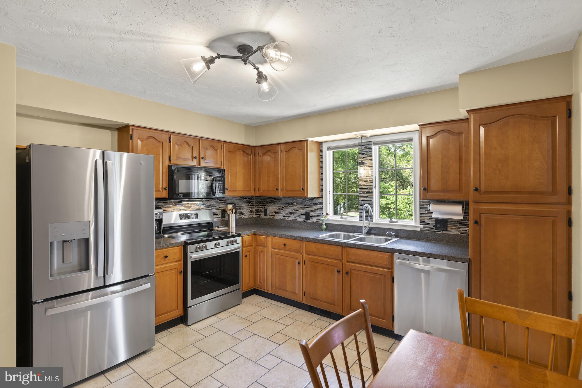 95 White Church Road Gettysburg, PA 17325 - Photo 19 of 59 a kitchen with stainless steel appliances granite countertop a refrigerator a stove a sink and a refrigerator