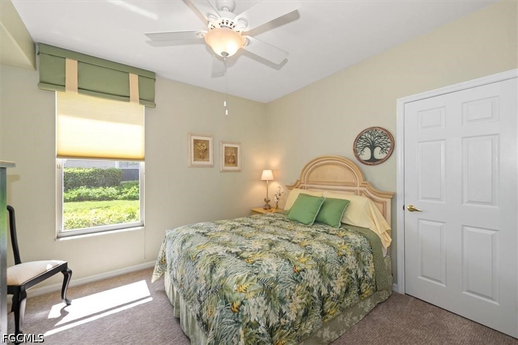 11033 Mill Creek Way, Unit 202 Fort Myers, FL 33913 - Photo 12 of 15 a bedroom with a bed and a window