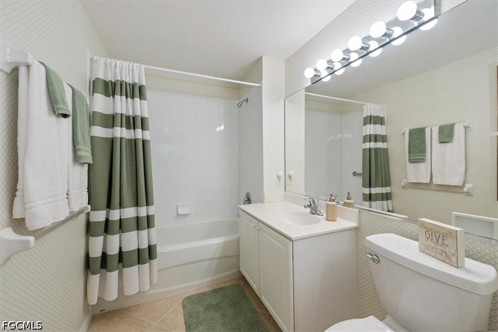 11033 Mill Creek Way, Unit 202 Fort Myers, FL 33913 - Photo 13 of 15 a bathroom with a bathtub shower sink vanity and toilet