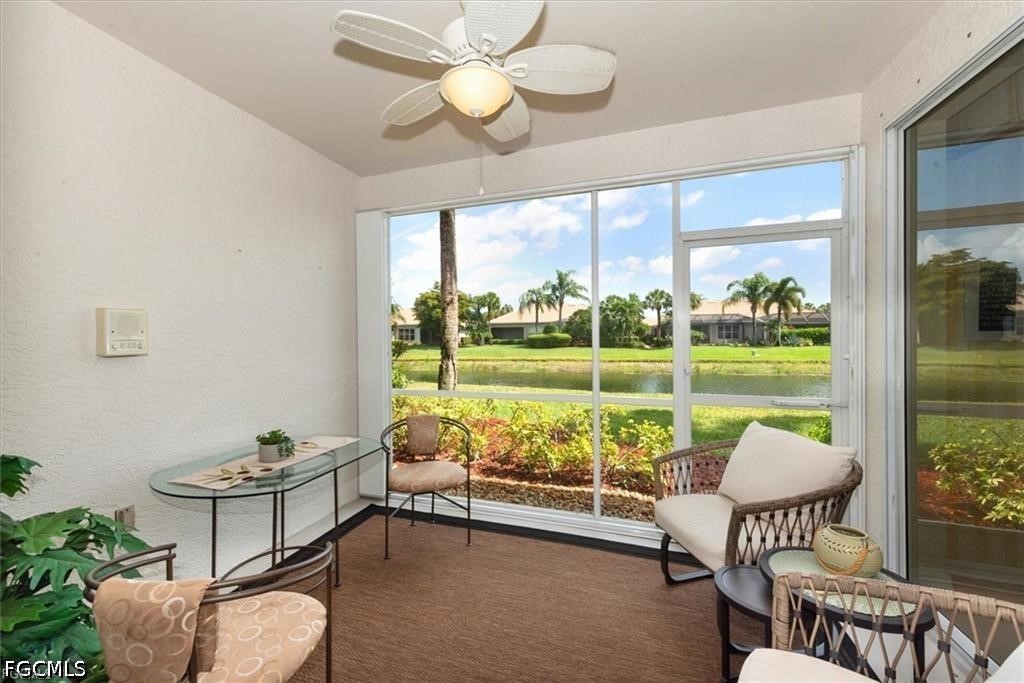11033 Mill Creek Way, Unit 202 Fort Myers, FL 33913 - Photo 14 of 15 a living room with furniture and a floor to ceiling window