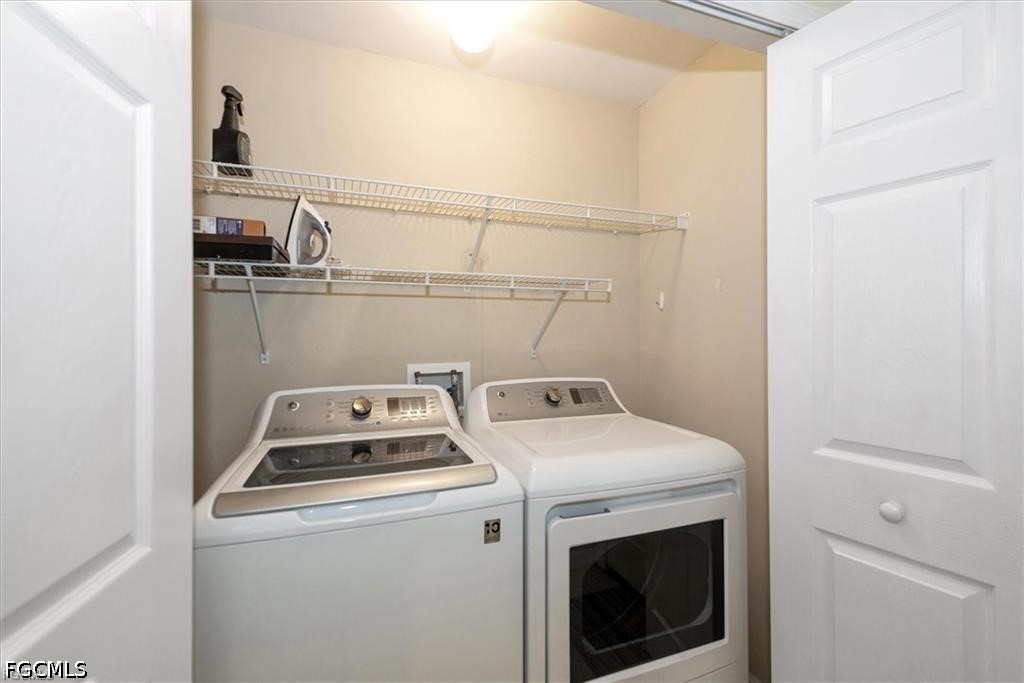 11033 Mill Creek Way, Unit 202 Fort Myers, FL 33913 - Photo 15 of 15 a utility room with dryer and washer