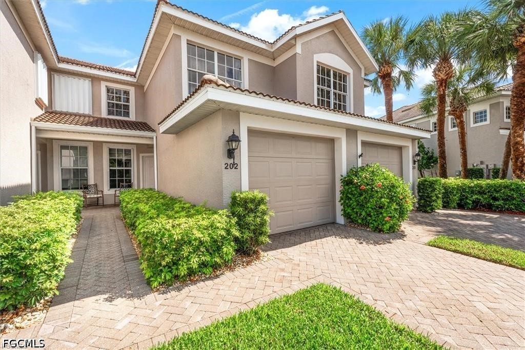 11033 Mill Creek Way, Unit 202 Fort Myers, FL 33913 - Photo 2 of 15 front view of a house with a yard