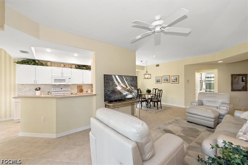 11033 Mill Creek Way, Unit 202 Fort Myers, FL 33913 - Photo 4 of 15 a living room with furniture and kitchen view