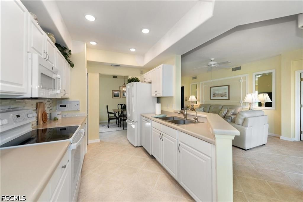 11033 Mill Creek Way, Unit 202 Fort Myers, FL 33913 - Photo 6 of 15 a large white kitchen with a lot of counter space