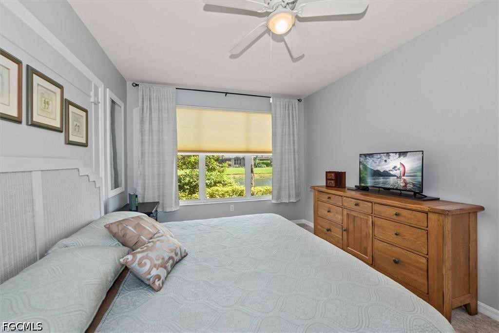 11033 Mill Creek Way, Unit 202 Fort Myers, FL 33913 - Photo 10 of 15 a bedroom with a bed and a window