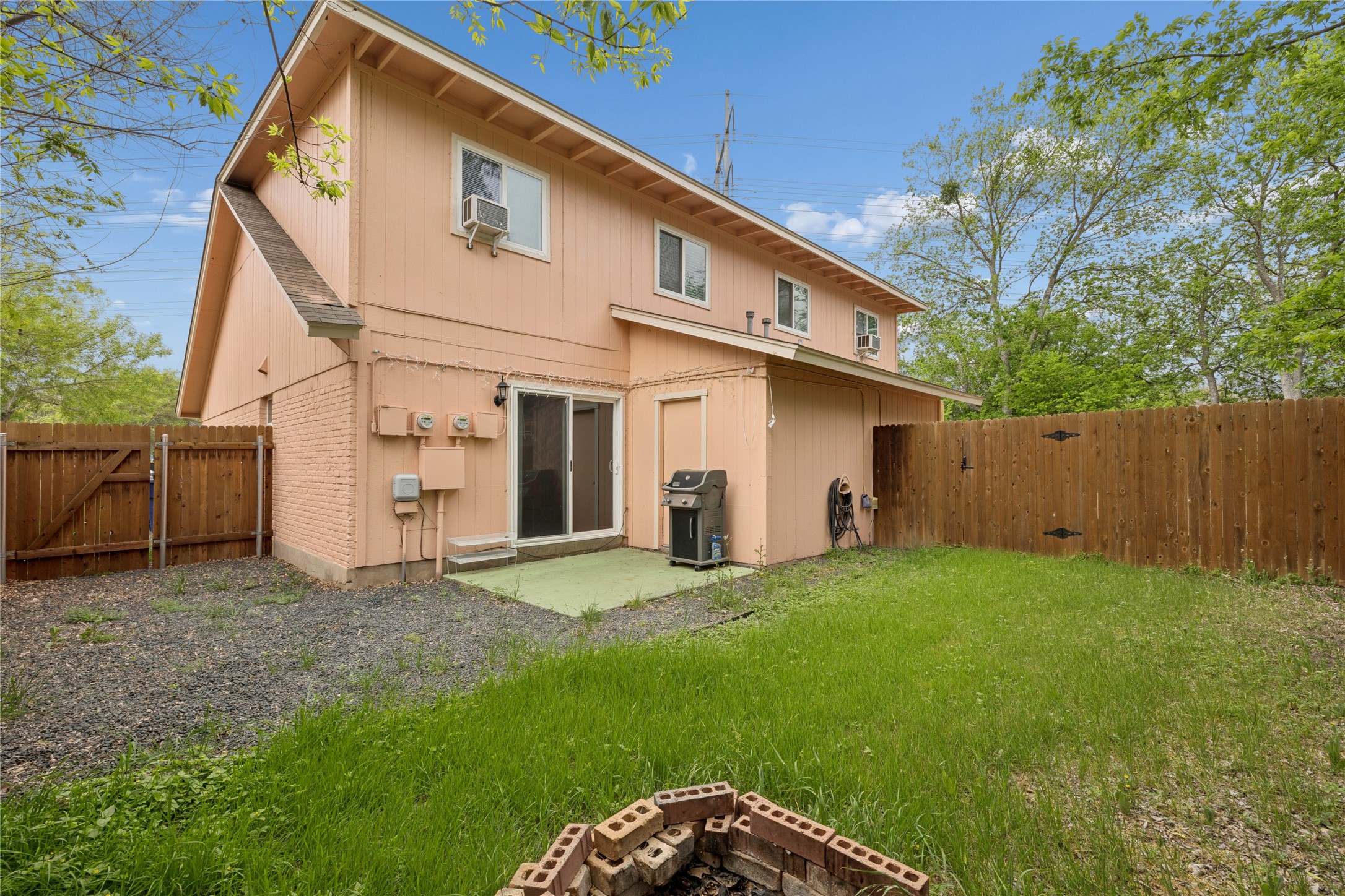 820 Sahara Avenue, Unit B Austin, TX 78745 - Photo 16 of 29 Back of house featuring a gate, a patio area, a fenced backyard, and brick siding