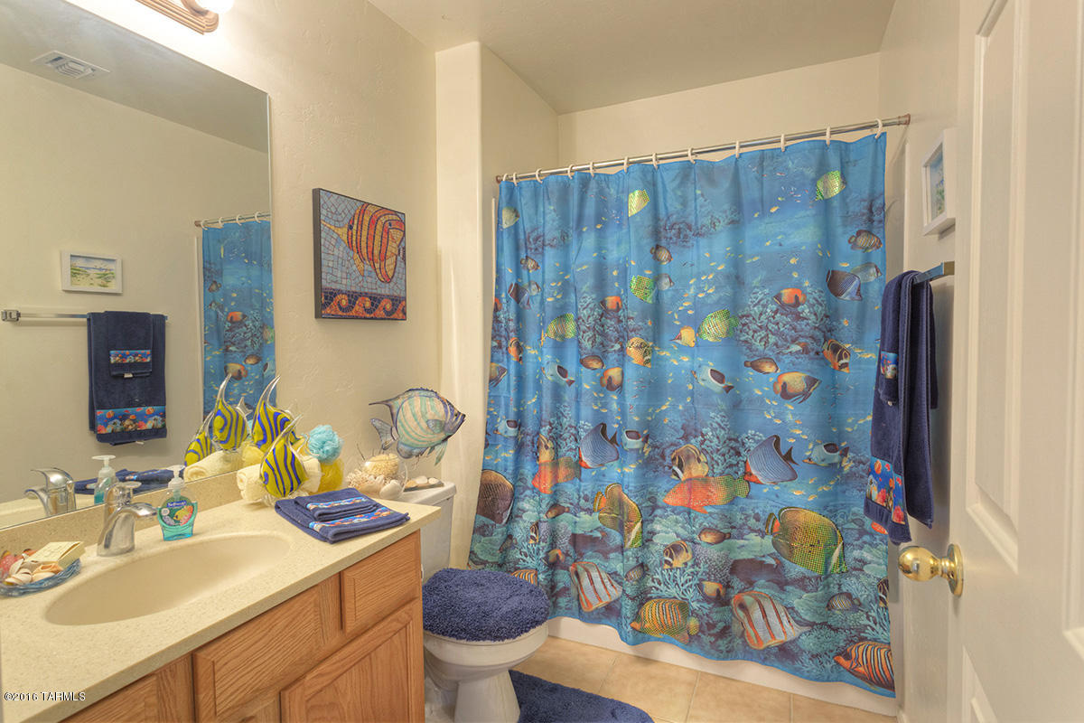 1778 Guess Court Rio Rico, AZ 85648 - Photo 10 of 19 a bathroom with a sink mirror vanity and toilet