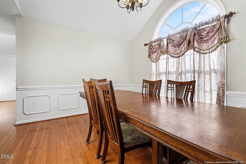 831 Raspberry Road Stedman, NC 28391 - Photo 11 of 35 a view of a dining room with furniture and wooden floor