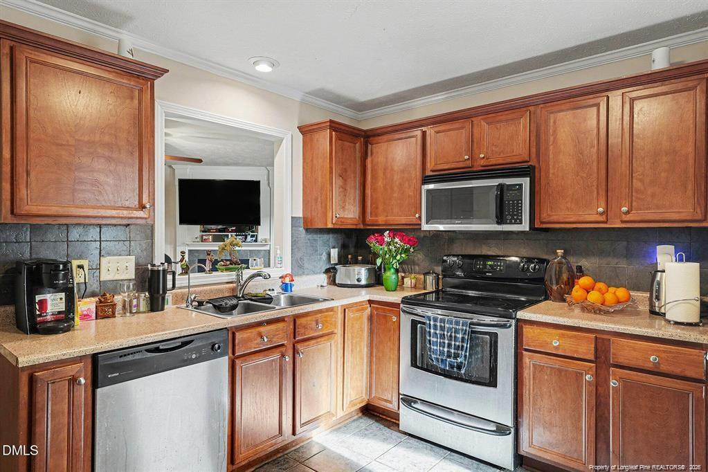 831 Raspberry Road Stedman, NC 28391 - Photo 12 of 35 a kitchen with stainless steel appliances granite countertop a stove a sink and a microwave
