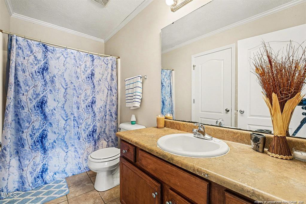 831 Raspberry Road Stedman, NC 28391 - Photo 15 of 35 a bathroom with a granite countertop sink and a mirror