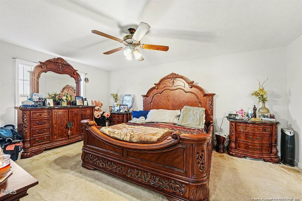 831 Raspberry Road Stedman, NC 28391 - Photo 17 of 35 a living room with furniture and a chandelier