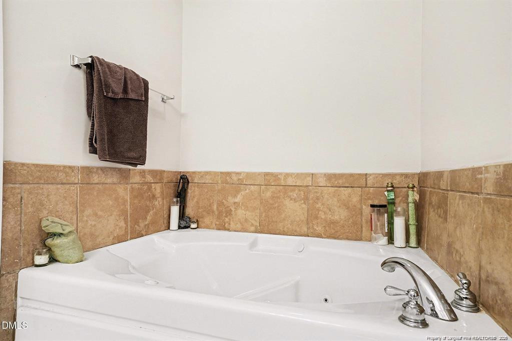 831 Raspberry Road Stedman, NC 28391 - Photo 22 of 35 a bathroom with a bathtub