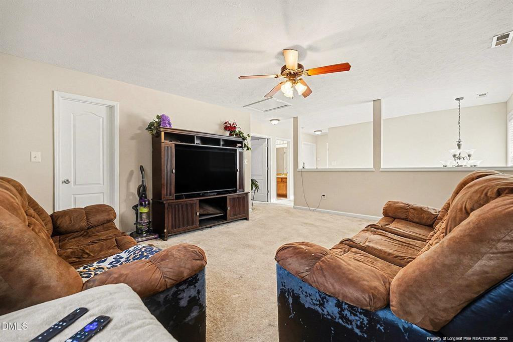 831 Raspberry Road Stedman, NC 28391 - Photo 26 of 35 a living room with furniture and a flat screen tv