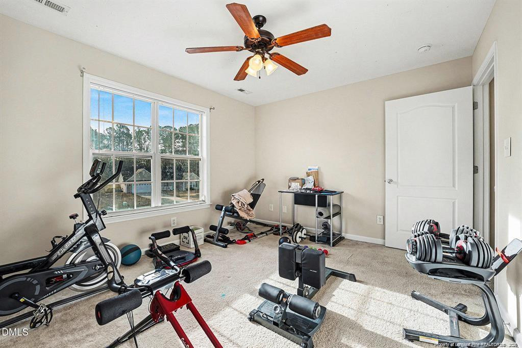 831 Raspberry Road Stedman, NC 28391 - Photo 28 of 35 a room with gym equipment and a large window