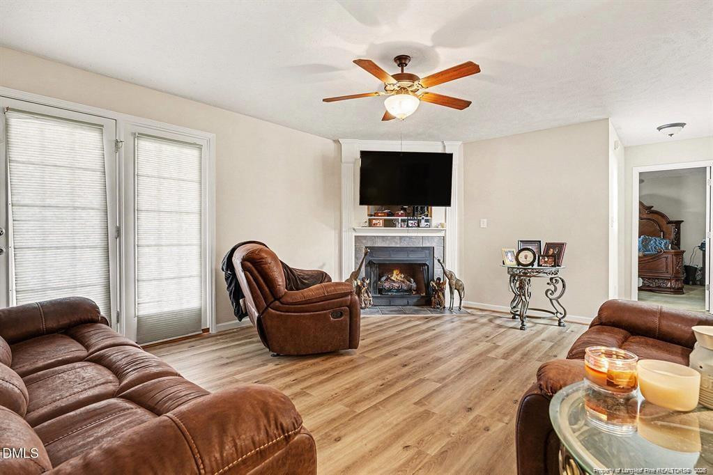 831 Raspberry Road Stedman, NC 28391 - Photo 8 of 35 a living room with furniture a flat screen tv and a large window
