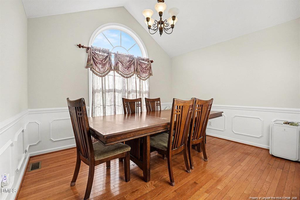 831 Raspberry Road Stedman, NC 28391 - Photo 10 of 35 a view of a dining room with furniture window and wooden floor