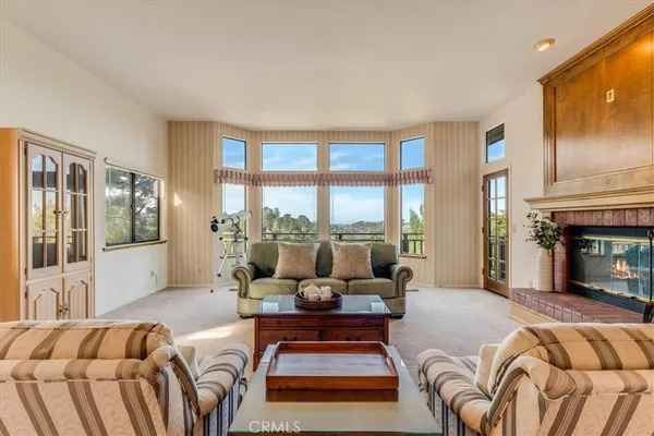 a view of a balcony with wooden floor and fence