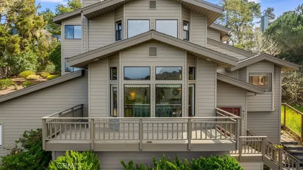a view of a patio with table and chairs and floor to ceiling window
