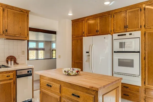 a spacious bathroom with a double vanity sink a large mirror and a bathtub
