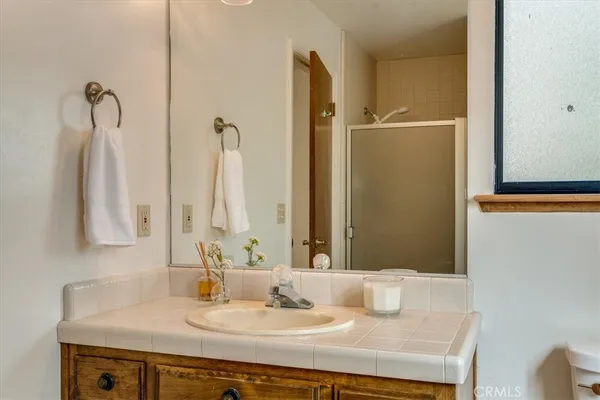 an aerial view of a house with yard and green space