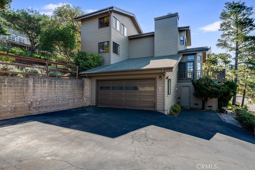 3171 Rogers Road Cambria, CA 93428 - Photo 60 of 73 a front view of a house with a garden